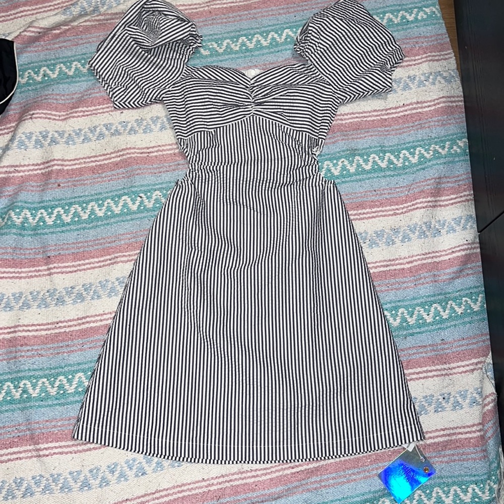 Dark blue and white striped dress with puff sleeves and waist cutouts